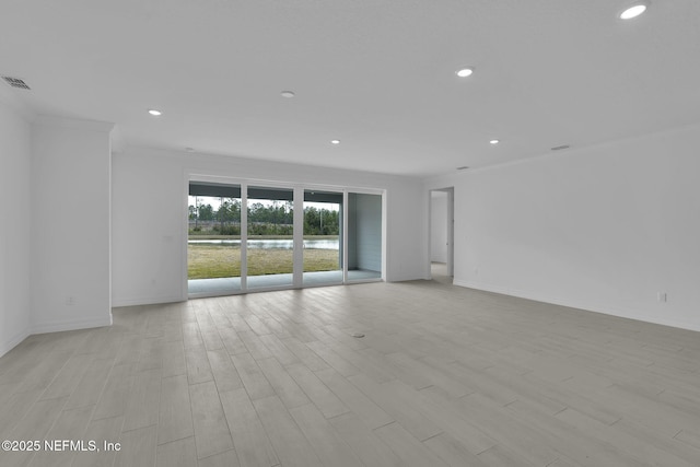 unfurnished room featuring recessed lighting, light wood-type flooring, and ornamental molding