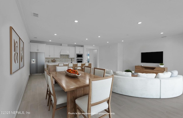 dining room featuring light wood finished floors, visible vents, and recessed lighting