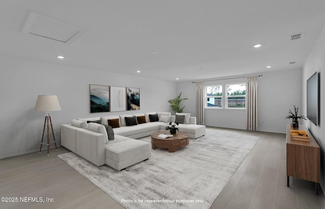 living room featuring visible vents, wood finished floors, recessed lighting, baseboards, and attic access