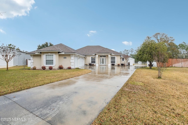 view of front of home featuring a front lawn and a garage