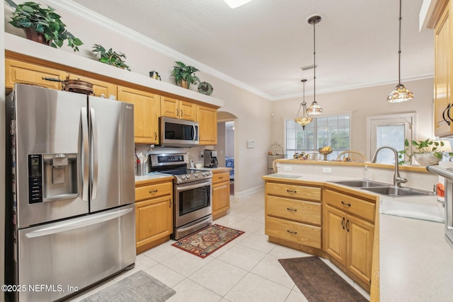 kitchen with stainless steel appliances, ornamental molding, pendant lighting, sink, and light tile patterned flooring