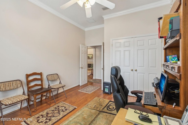 home office featuring ceiling fan, ornamental molding, and hardwood / wood-style flooring