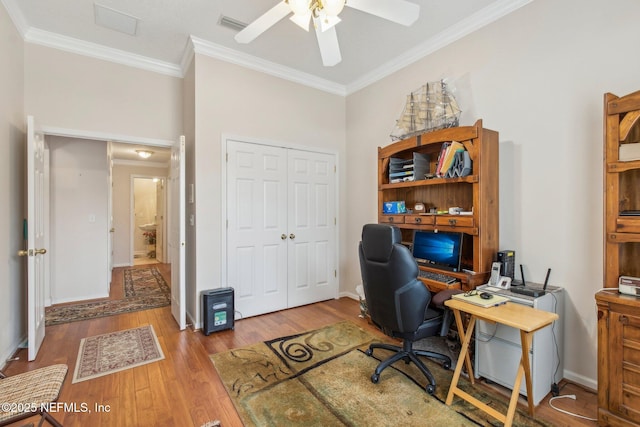 office space with crown molding, ceiling fan, and light hardwood / wood-style flooring