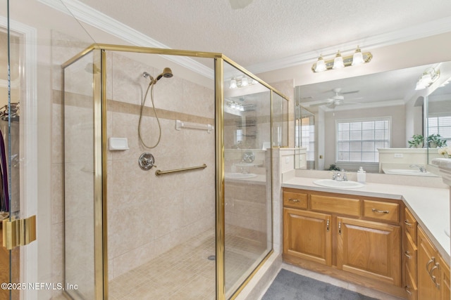 bathroom with ceiling fan, a shower with door, crown molding, and vanity