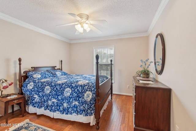 bedroom featuring ornamental molding, a textured ceiling, ceiling fan, and hardwood / wood-style flooring