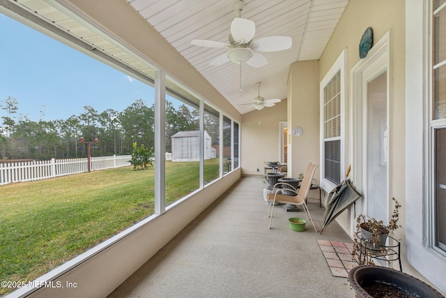 sunroom / solarium featuring ceiling fan and vaulted ceiling