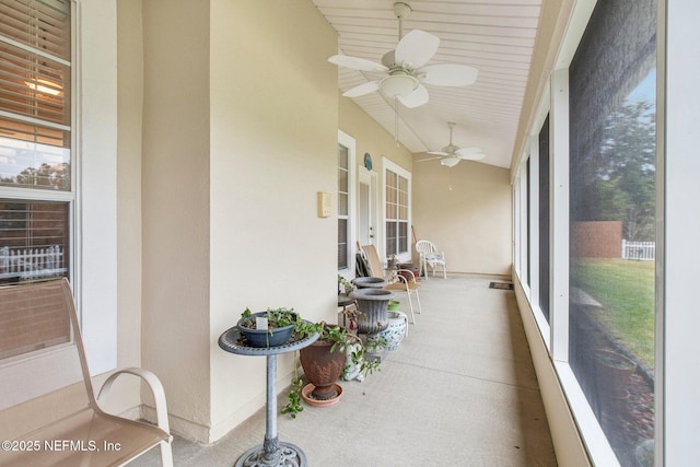 sunroom with lofted ceiling and ceiling fan