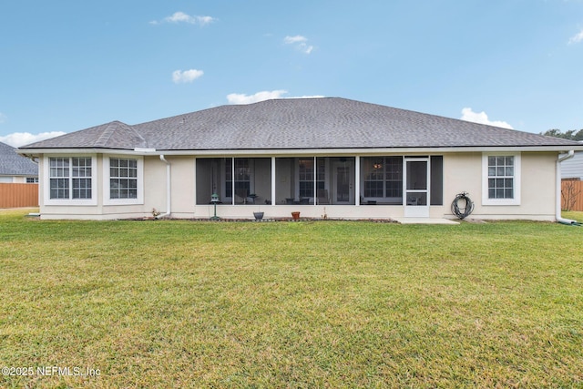 back of house with a lawn and a sunroom