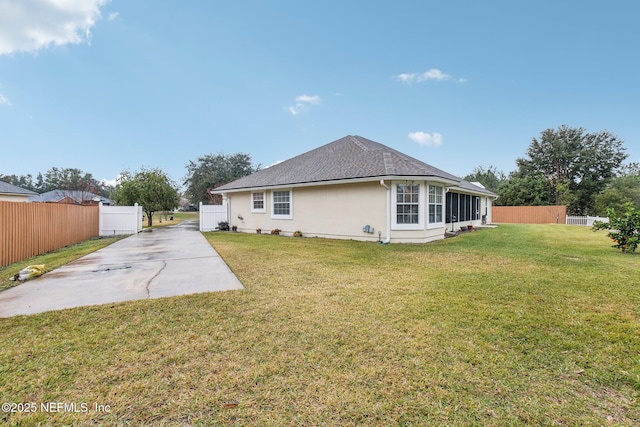 back of property featuring a patio and a lawn