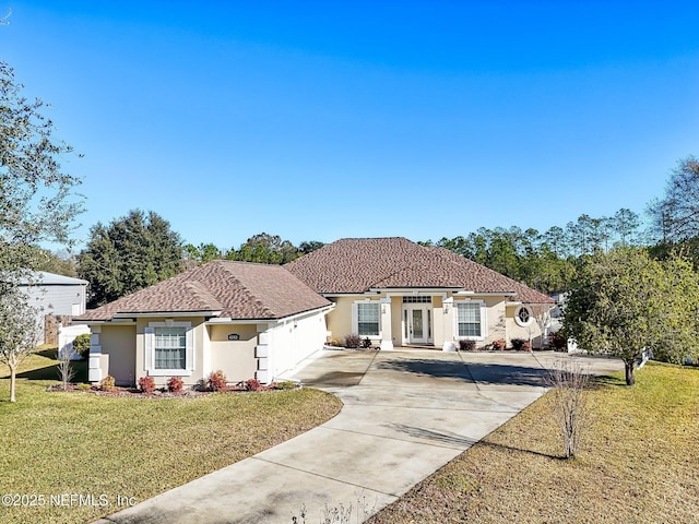 mediterranean / spanish house featuring a front lawn and a garage