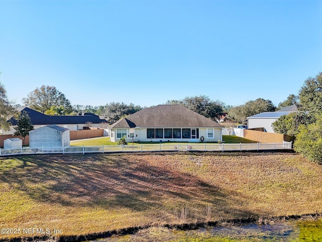 view of front of home featuring a shed and a front lawn