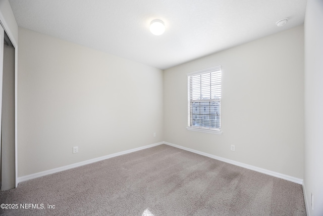 unfurnished room featuring carpet