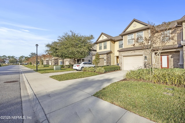 view of front of house featuring a garage and a front lawn