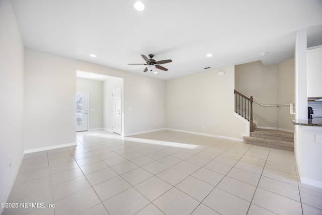 spare room with ceiling fan and light tile patterned floors