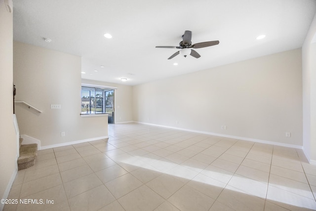 empty room featuring ceiling fan and light tile patterned floors