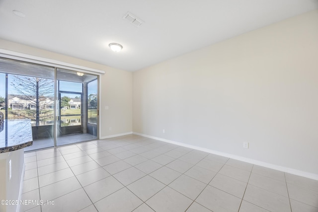 unfurnished room featuring light tile patterned floors