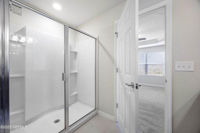 bathroom with tile patterned flooring and a shower with door