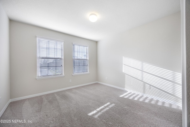 unfurnished room featuring carpet flooring