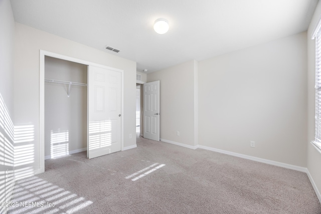 unfurnished bedroom featuring carpet floors and a closet