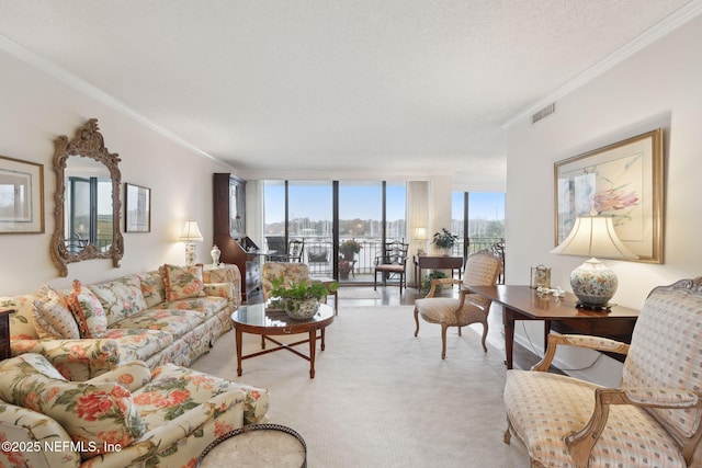 living room featuring expansive windows, ornamental molding, a textured ceiling, and light carpet