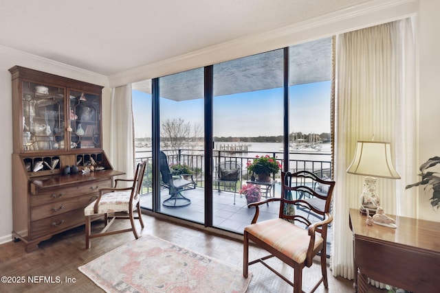 office area featuring ornamental molding, plenty of natural light, hardwood / wood-style floors, and a wall of windows