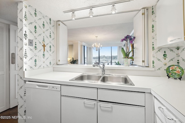 kitchen with white cabinets, a textured ceiling, sink, dishwasher, and a chandelier