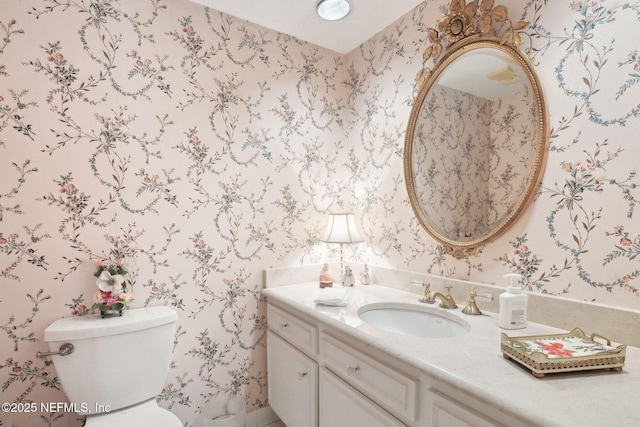 bathroom featuring vanity and toilet