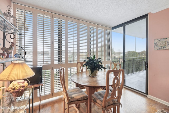 dining room with parquet flooring and a textured ceiling