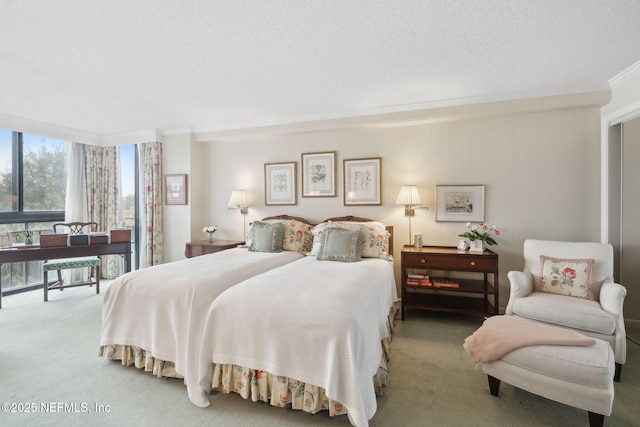 bedroom featuring carpet flooring, crown molding, and a textured ceiling