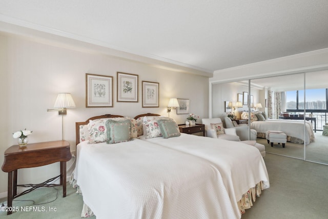 bedroom with a closet, carpet floors, and ornamental molding