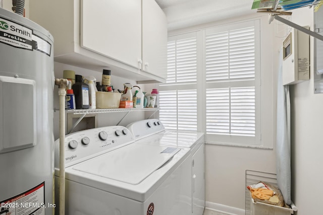 washroom with electric water heater, cabinets, and independent washer and dryer