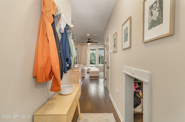 interior space featuring ceiling fan and dark wood-type flooring