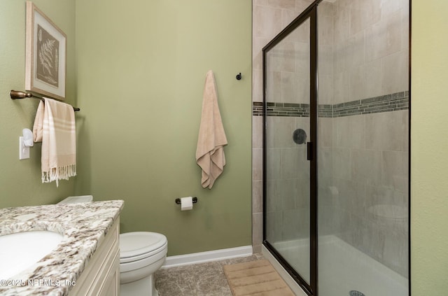 bathroom featuring vanity, toilet, tile patterned floors, and a shower with door