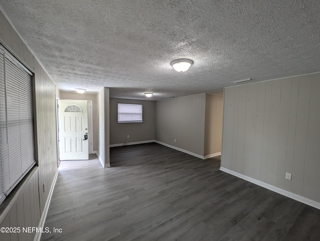 basement featuring dark hardwood / wood-style flooring and wood walls