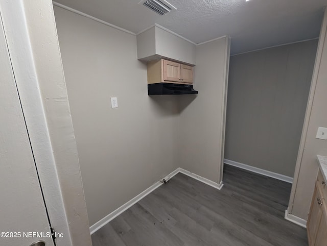 laundry room with dark hardwood / wood-style floors and a textured ceiling