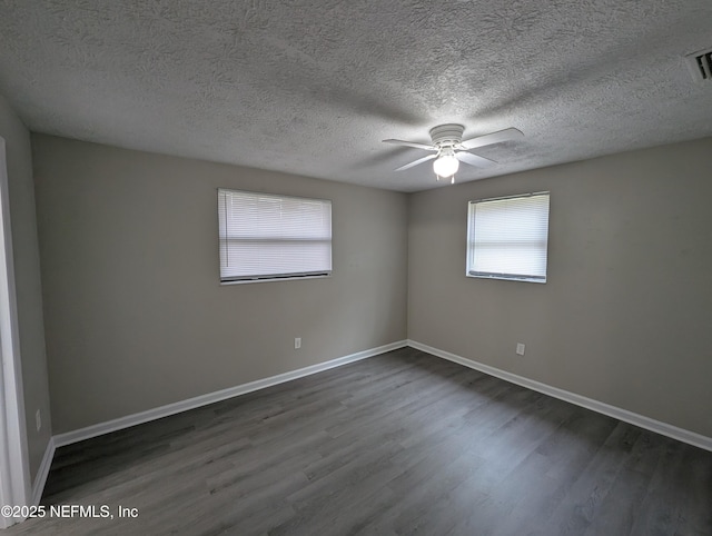 spare room with a textured ceiling, dark hardwood / wood-style flooring, and ceiling fan