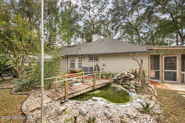 back of property featuring a sunroom and a wooden deck