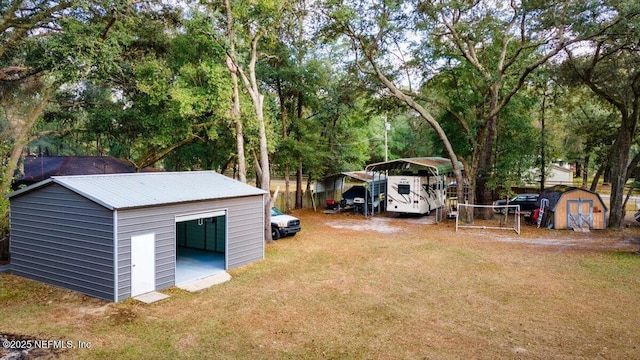 view of yard with a carport and a storage unit