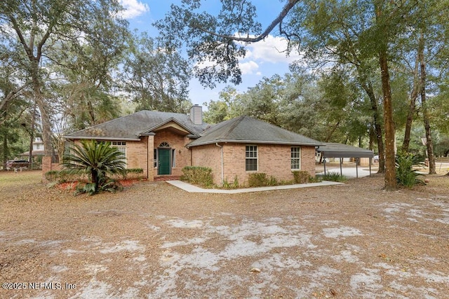 ranch-style house featuring a carport