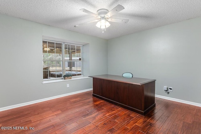 office area featuring ceiling fan, dark wood-type flooring, and a textured ceiling