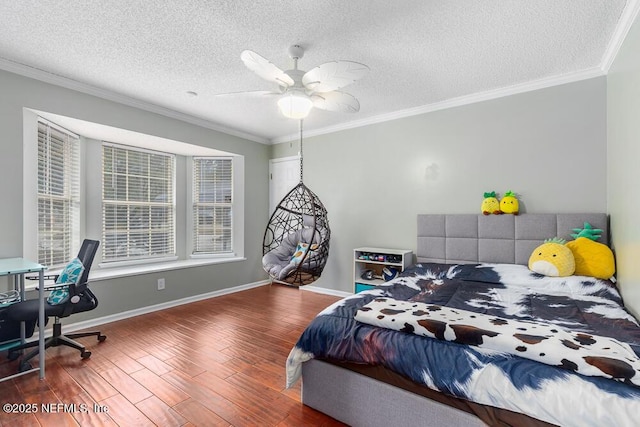 bedroom featuring ceiling fan, hardwood / wood-style floors, crown molding, and a textured ceiling