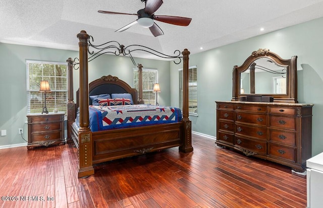 bedroom featuring ceiling fan, dark hardwood / wood-style flooring, a textured ceiling, and vaulted ceiling