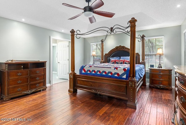 bedroom featuring a textured ceiling, ceiling fan, and dark wood-type flooring