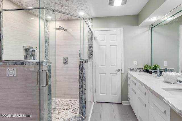 bathroom with vanity, tile patterned floors, and an enclosed shower