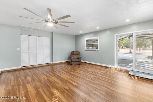 unfurnished room featuring ceiling fan, light hardwood / wood-style floors, and a textured ceiling