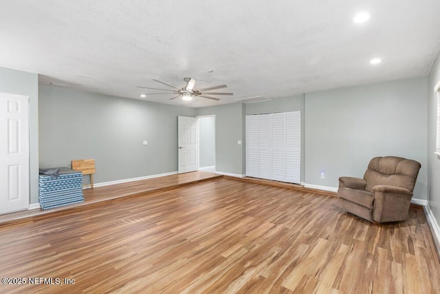 sitting room featuring light hardwood / wood-style floors and ceiling fan