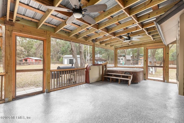 unfurnished sunroom with plenty of natural light and ceiling fan