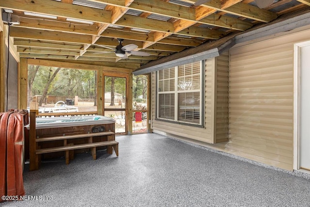 unfurnished sunroom featuring ceiling fan