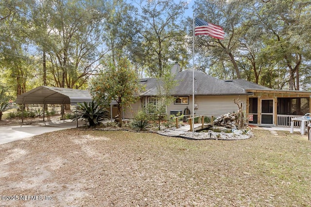 back of house with a sunroom and a carport