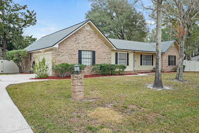 ranch-style home featuring a garage and a front lawn